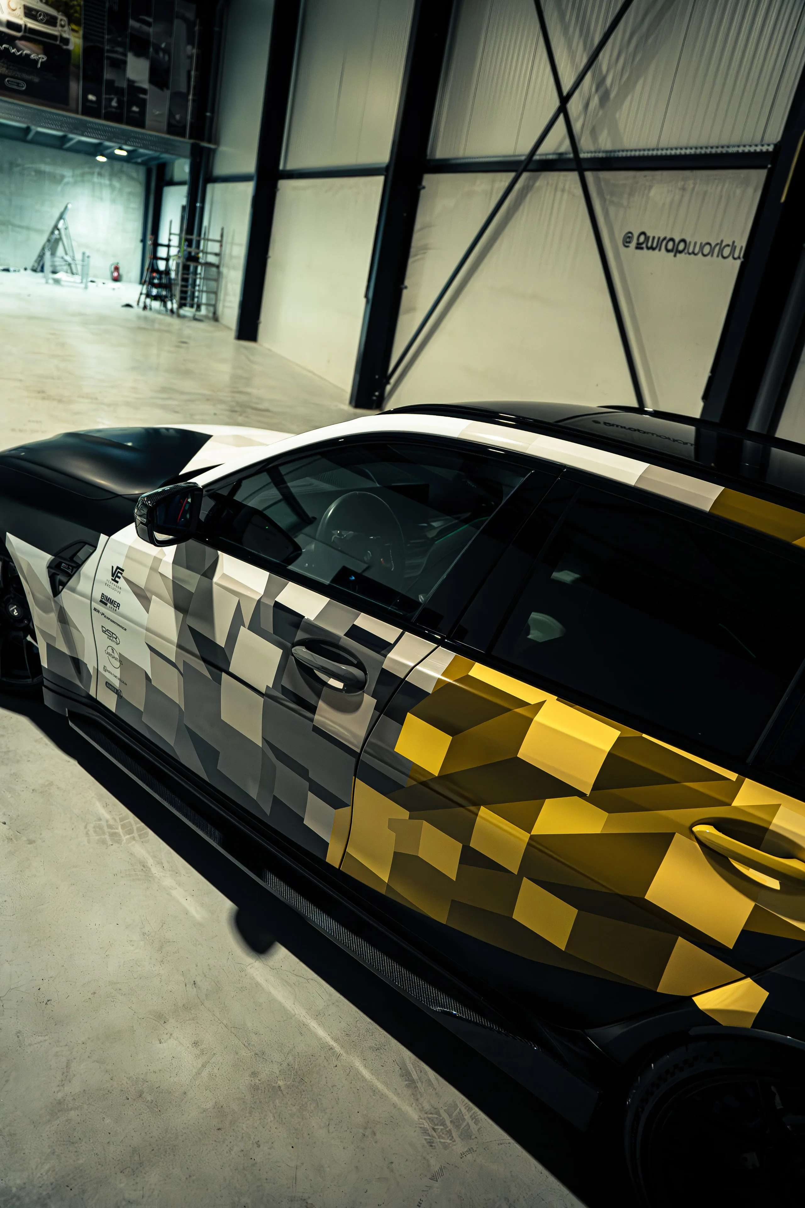 BMW M3 Touring met een op de racerij geïnspireerde design wrap in wit, grijs en goud