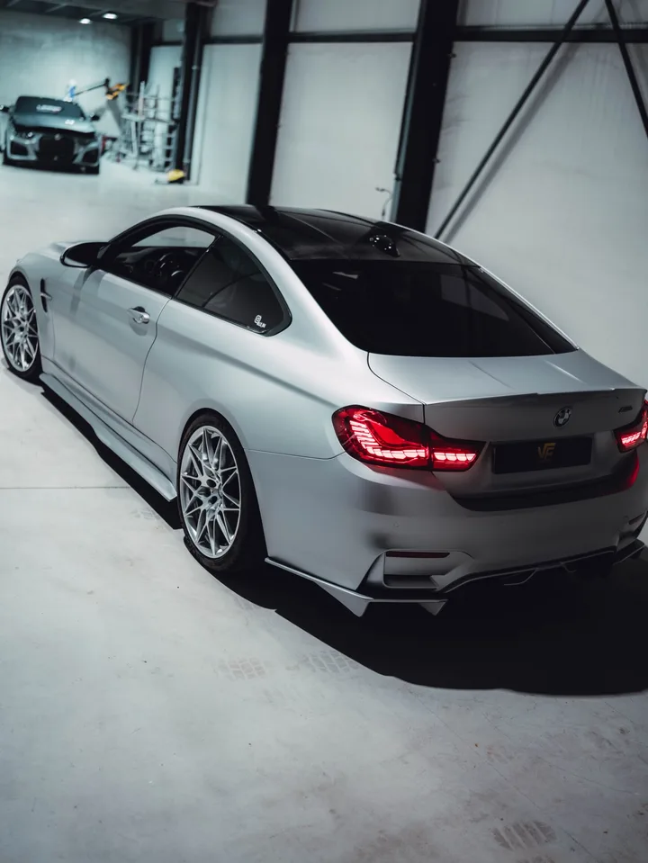 BMW M4 in Satin White Aluminium schuin van achteren in de hal