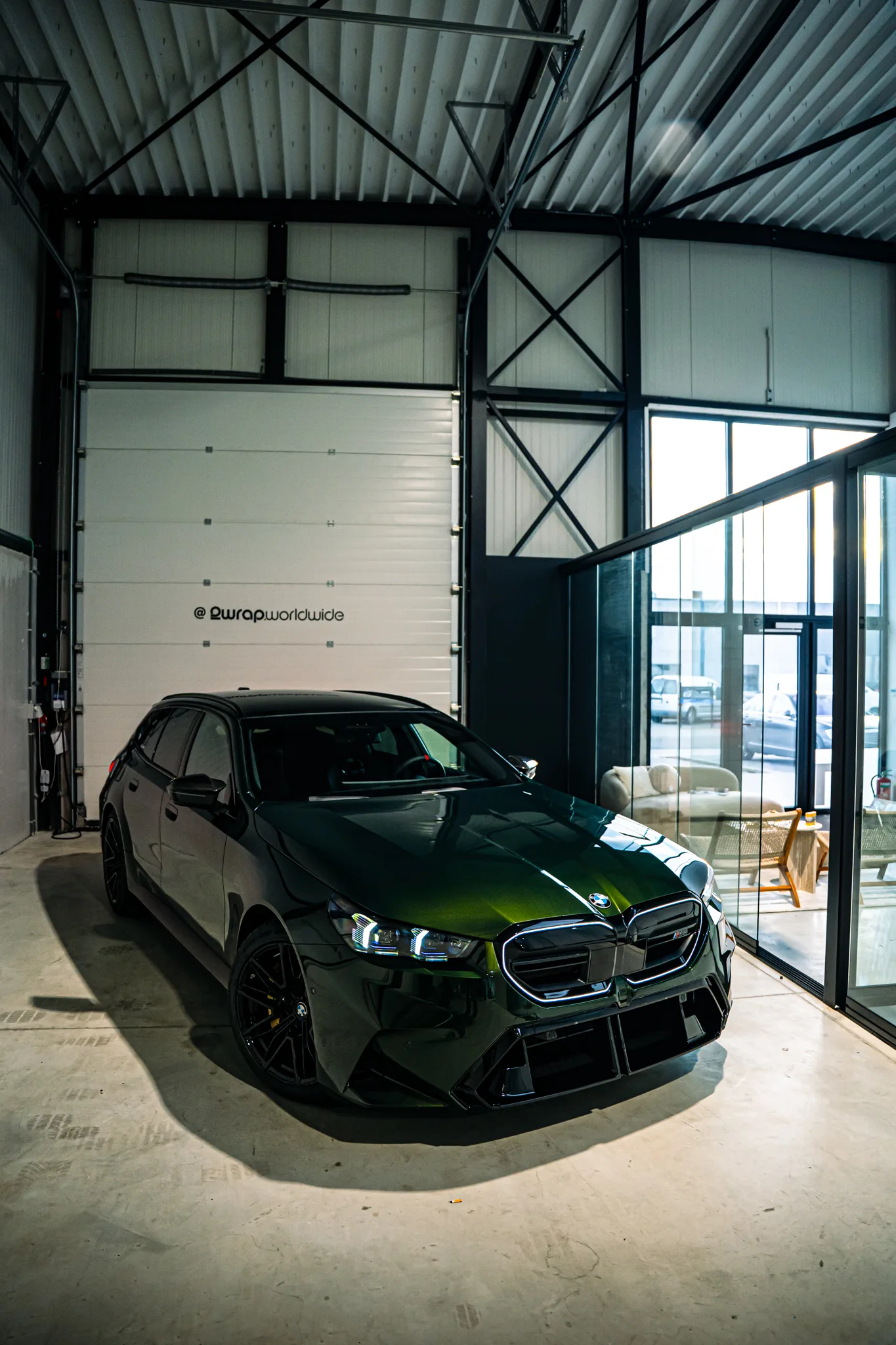 BMW M5 Touring in Individual San Remo Green in de hal, schuin van voren